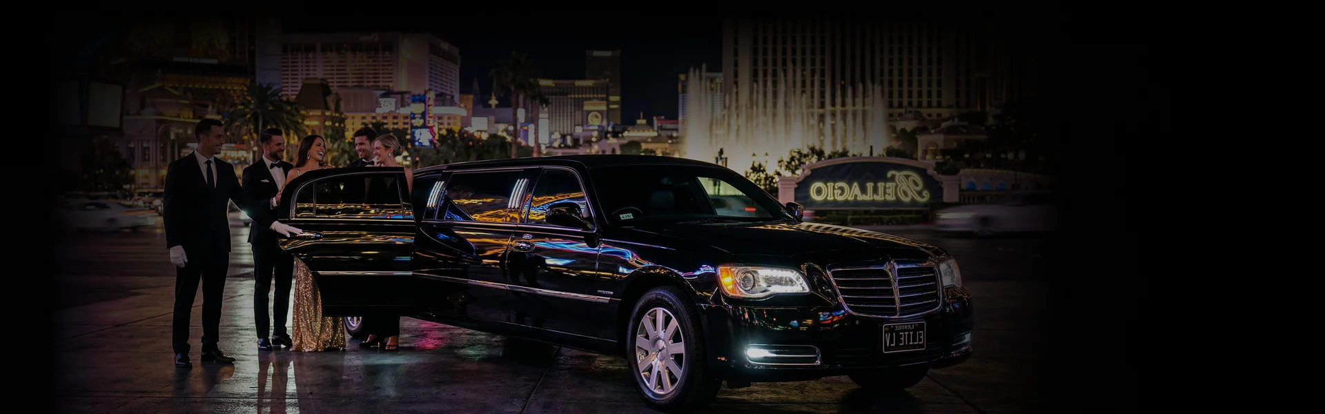 A group of well-dressed passengers stepping out of a luxury stretch limousine with chauffeurs assisting on a vibrant Las Vegas Strip at night.